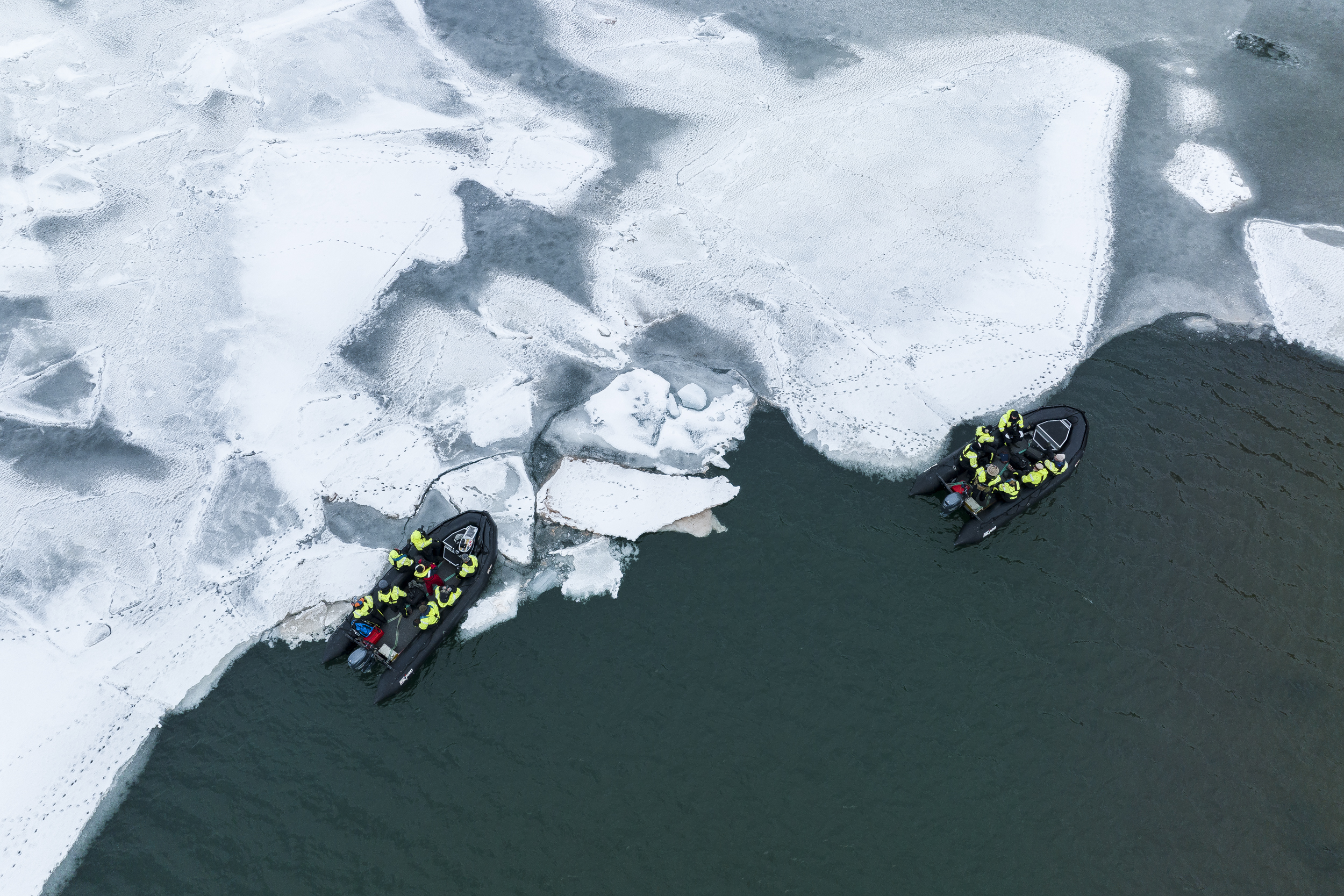 Zodiacs cruising along the ice edge, Svalbard