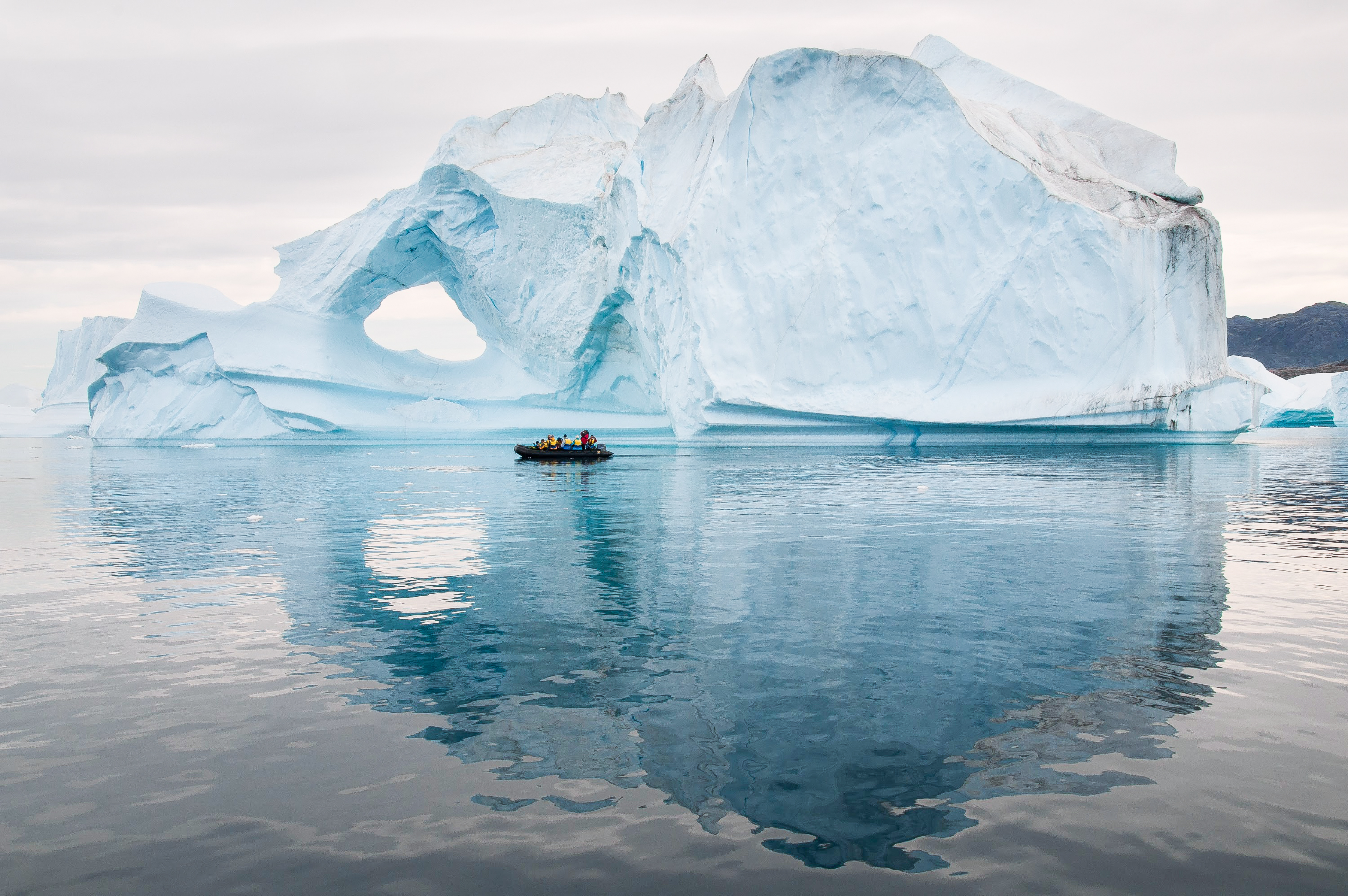 Zodiac excursion up close to an iceberg in Scoresbysund, Greenland