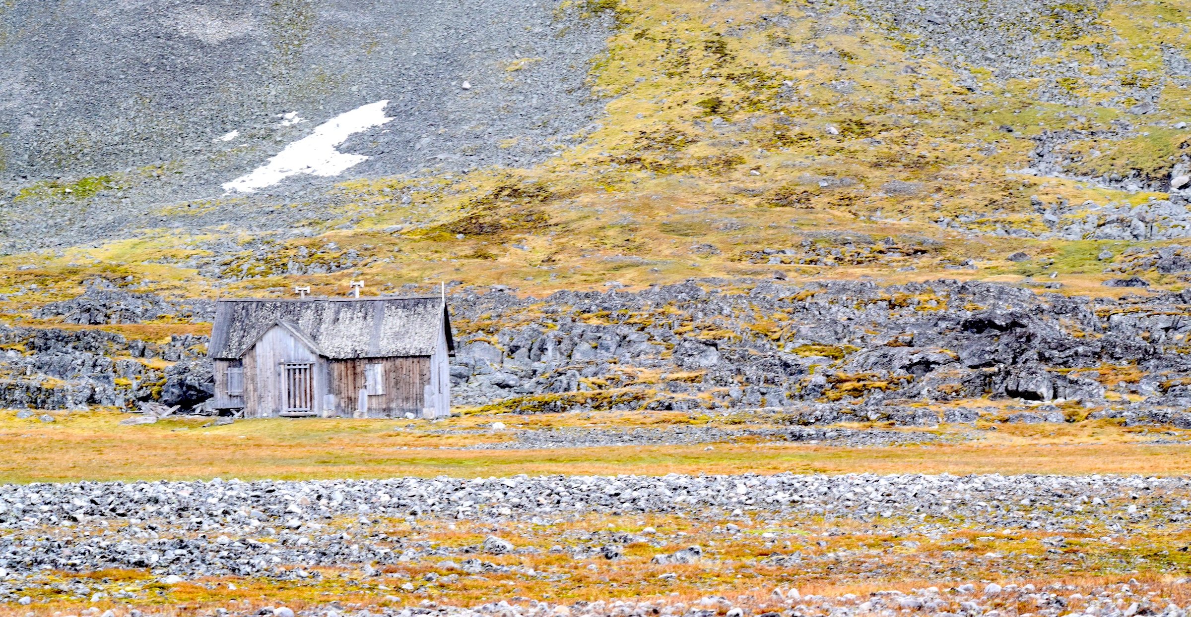 A hut sits amid the sparsely populated landscape of Svalbard, the Arctic