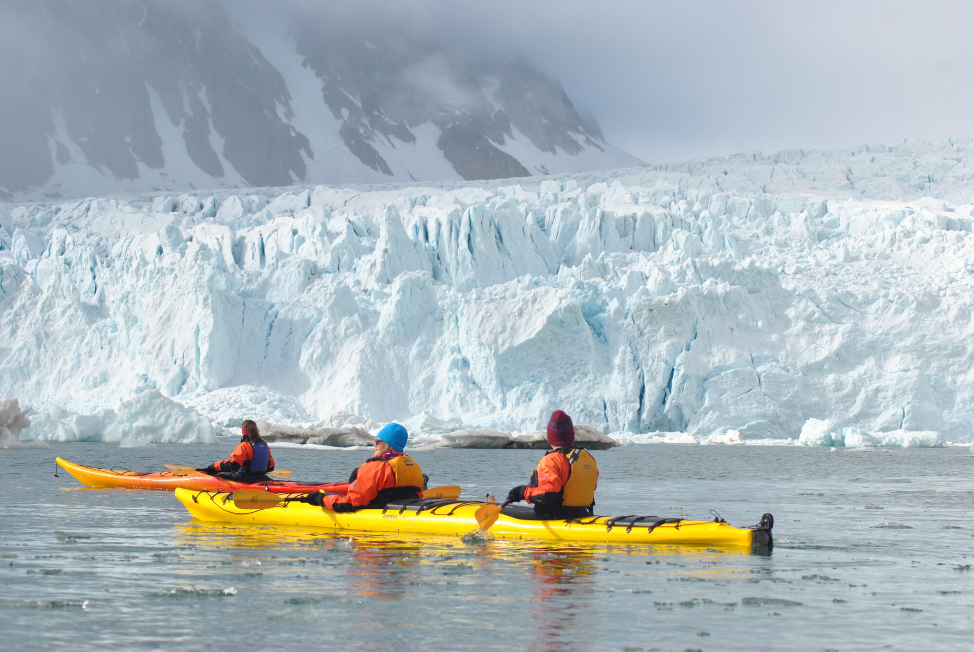 Kayaking close to a glacier in Svalbard