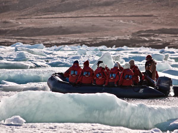 A zodiac navigates icebergs in the Northwest Passage