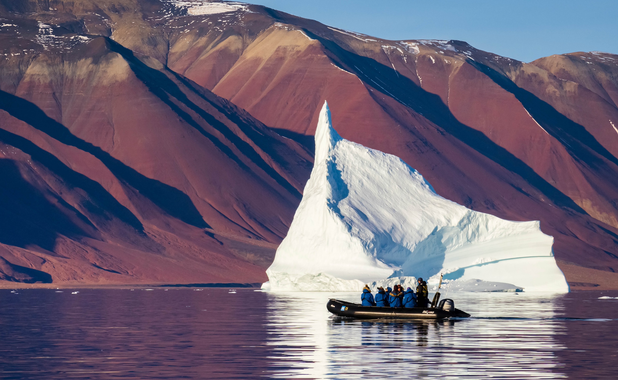 Guests explore Icebergs by Zodiac in Fleming Fjord, Northeast Greenland National Park, Greenland