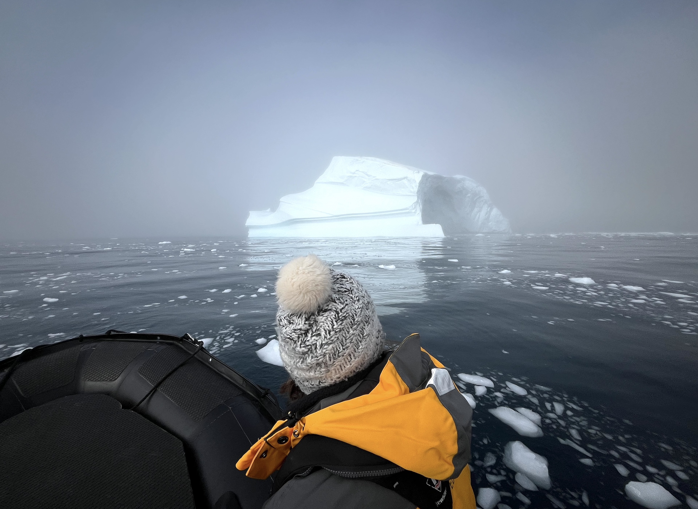 A passenger spots an iceberg from a zodiac cruise in West Greenland 