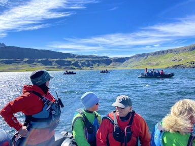 Guests on an expedition cruise explore Iceland by zodiac boat