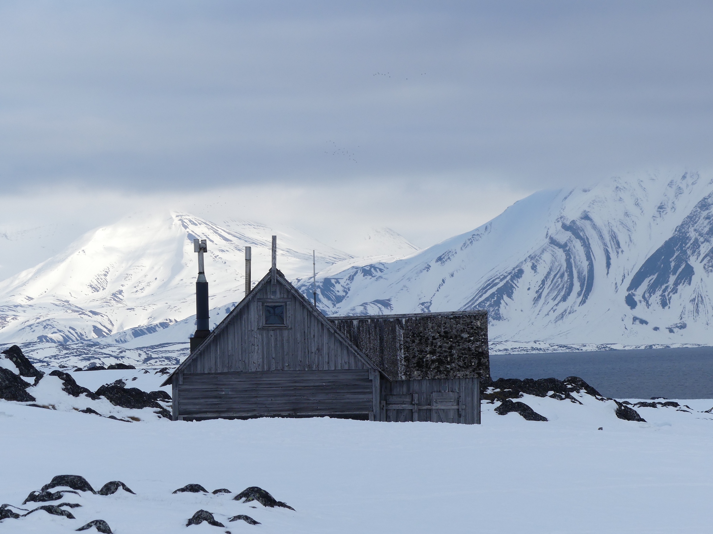 A hut sits alone in the snow in Svalbard 