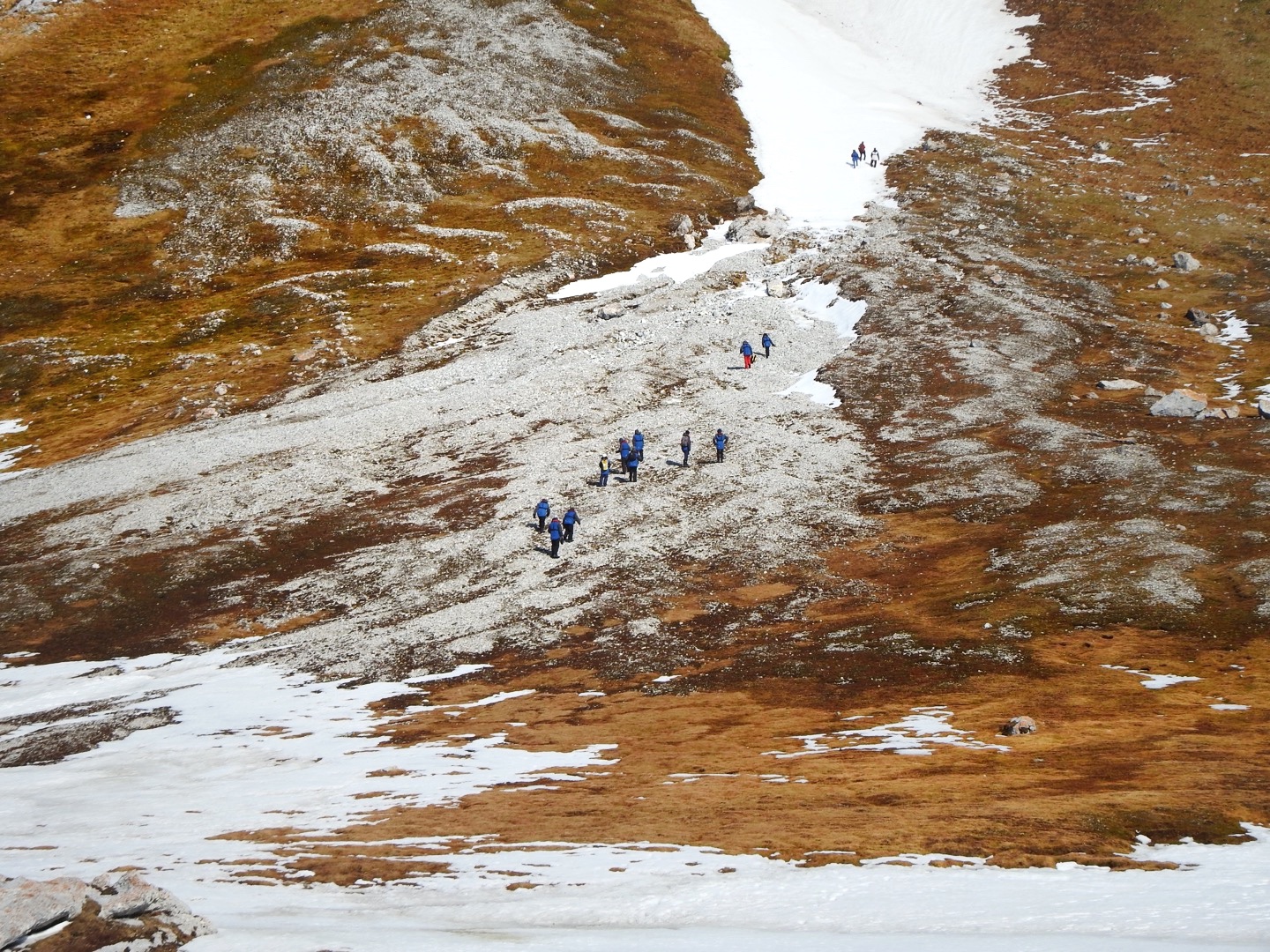 Guests climb a mountain while surrounded by the stark scenery of Gnalberget