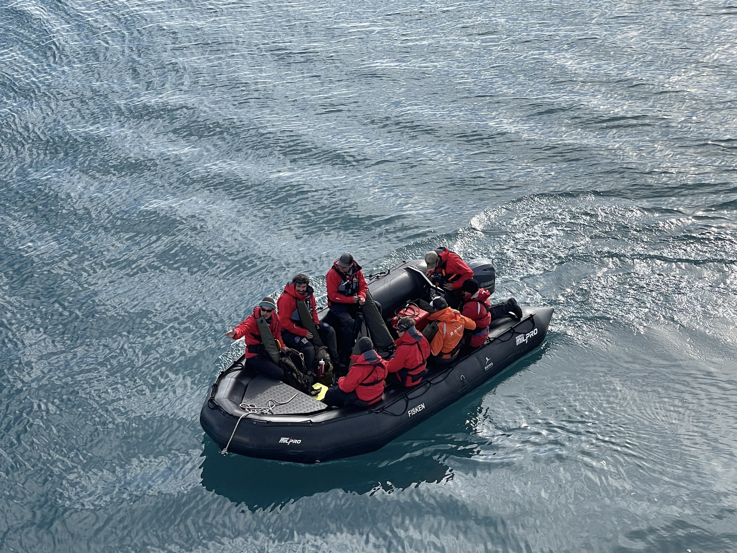 Passengers zodiac cruise through the Arctic waters in Svalbard